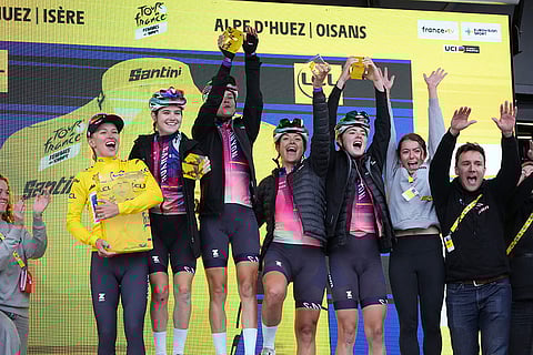 Tour de France Women cycling race: Winner Katarzyna Niewiadoma of Poland, wearing the overall leader's yellow jersey, and her team celebrate on the podium after the eighth stage